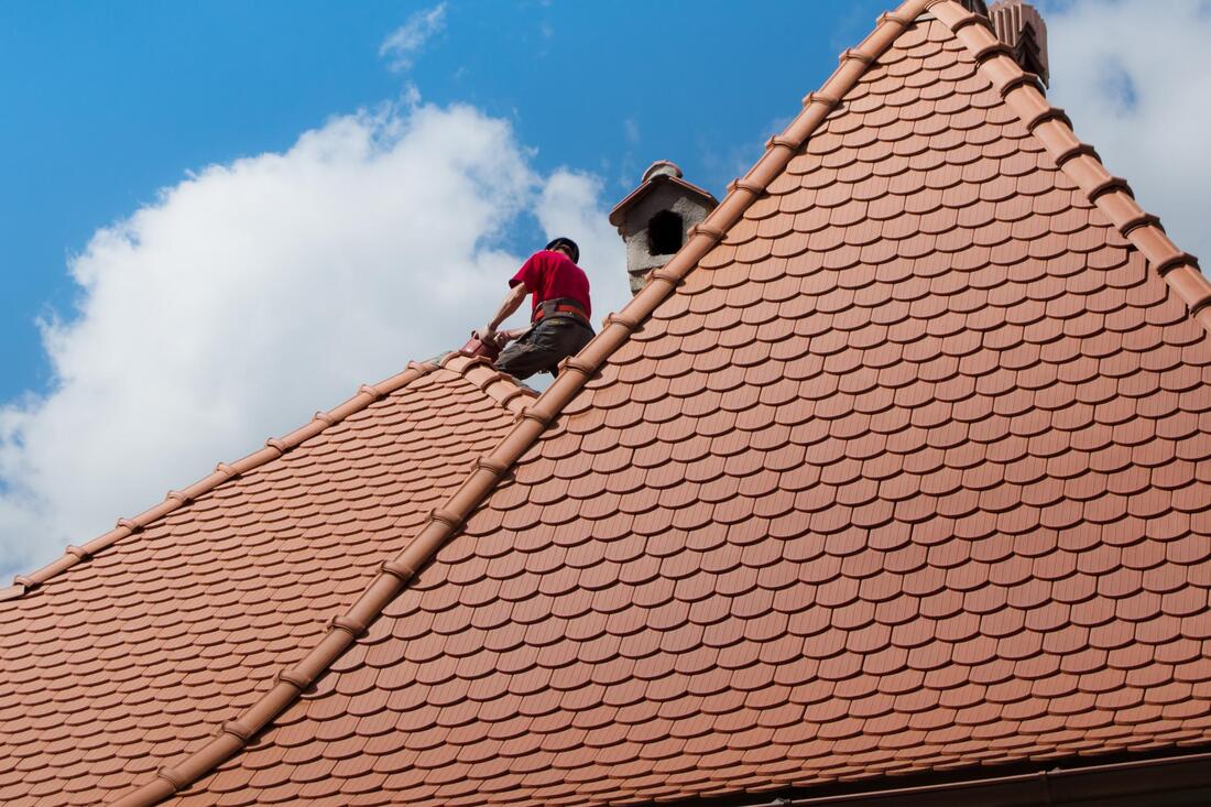 man repairs the roof